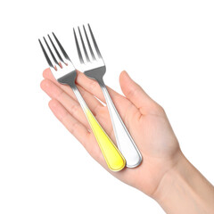 Two forks held in hand against dark background
