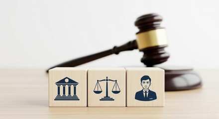 Legal Symbols and Justice: A wooden gavel rests behind wooden blocks, each bearing distinct legal symbols, representing concepts of law, justice and decision.