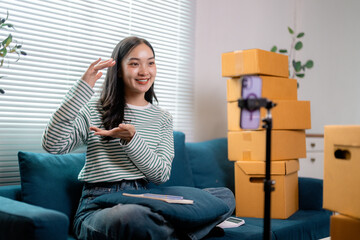 Young entrepreneur presenting products for sale, recording a video blog promoting her small business