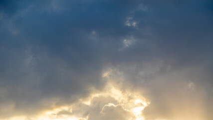 Grand sky with bright sun rays breaking through dark clouds, evening landscape, atmosphere, light,...