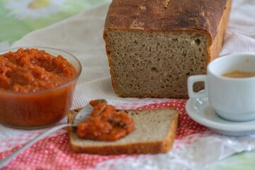 Rustic colonial rye bread, with chimia or pumpkin jam. Well-lit image, clear selective focus on the...
