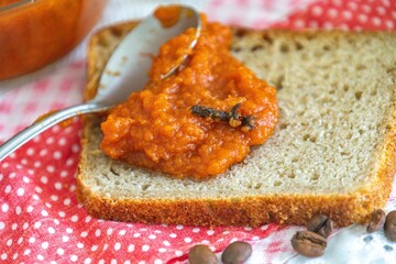 Rustic colonial rye bread, with chimia or pumpkin jam. Well-lit image, clear selective focus on the...