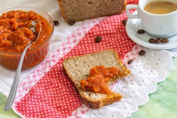 Rustic colonial rye bread, with chimia or pumpkin jam. Well-lit image, clear selective focus on the...