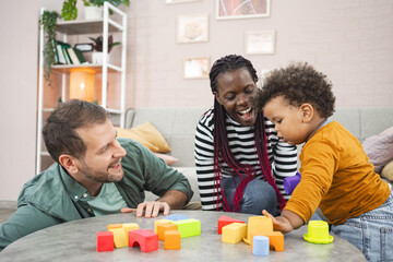 Multiracial family playing with colorful blocks at home