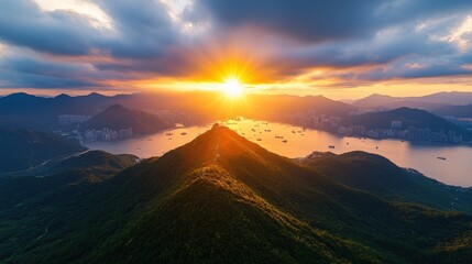 Obraz premium Majestic mountain landscape du vibrant sunrise with dramatic clouds over lush green peaks and tranquil water bodies
