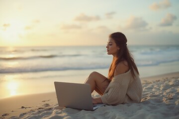 Young woman on beach daydreaming in front of  laptop