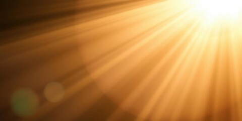Obraz premium Golden sunbeams radiating diagonally across a blurred amber background