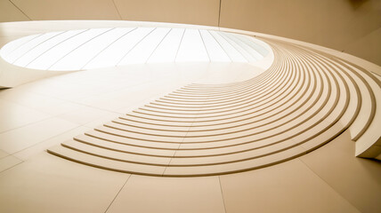 A minimalist architectural photograph of a curved white staircase with smooth, rounded steps that spiral upward.