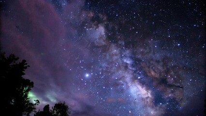 Fototapeta premium Cosmic Nebula with Purple and Green Gaseous Clouds in Dark Night Sky