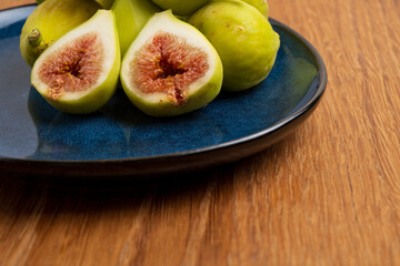 Fresh halved figs on blue plate
