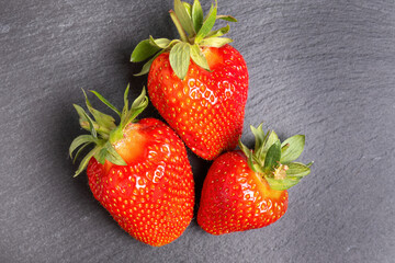 Fresh strawberries on dark slate background
