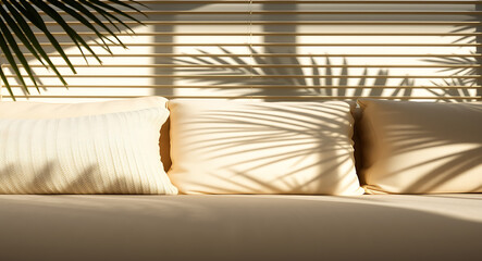 Cream pillows on couch with palm leaf shadows beige textured