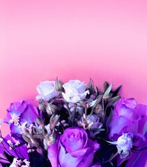 Bouquet of flowers on a pink background. Flat lay, top view.