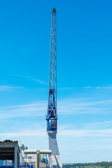 Towering crane amidst a clear blue sky at a busy construction site enhancing city infrastructure and progress