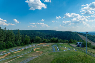 Experience the thrill of off-road biking on winding tracks surrounded by nature in a vibrant...