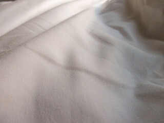 White blanket crumpled textile background messy. Fabric cotton background