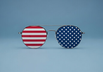 Round sunglasses, centered in the image, have lenses depicting the American flag