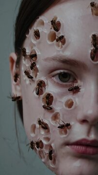 Trypophobic skin with lost of cluster holes with bees on a girls face.