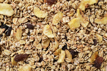 granola with freeze-dried bananas and raisins food background 