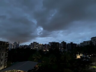 Scenic Evening Cityscape with Overcast Sky and Urban Skyline in a Residential Area, Evening Lights,...