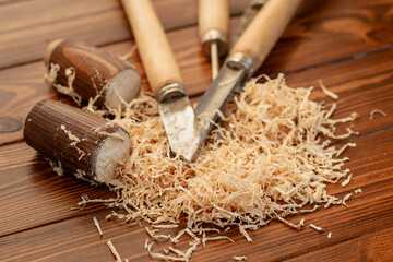 Carpentry tool set with wood shavings on wooden table