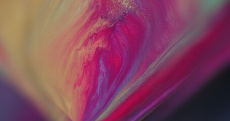 Flowing liquid. Shimmer ink. Defocused pink purple yellow colorful splash water particles sparkling...