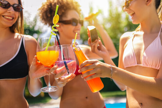 Group of Girl Friends Dancing and Partying by the Pool