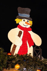 Wooden snowman on the roof of a Christmas hut, Darmstadt, Germany