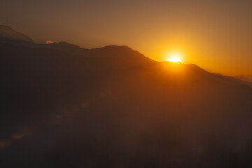 Sunrise over Himalayan peaks from Tadapani, Nepal - Serene mountain landscape with golden light.