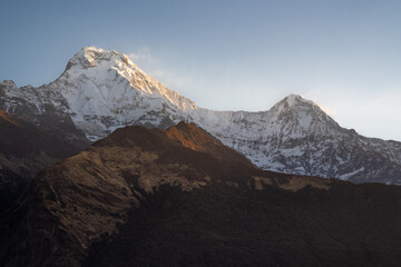 Panoramic sunrise view from Tadapani in Himalaya mountains, Nepal, showcasing the snow-capped peaks of the Annapurna ranges.