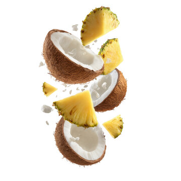 Fresh pineapple chunks and coconut halves flying together isolated on transparent background