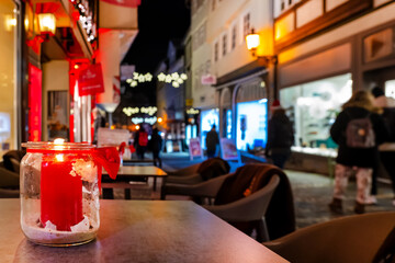 A burning candle at Christmas time in Marburg with blurred city background, Germany