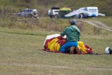 Extreme recreation. Aeroclub Chegem. Paragliders fold their paragliders after landing.