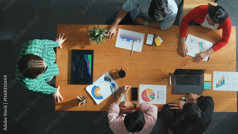 Poster top down view of manager holds tablet display increasing sales and placed on meeting table. group of