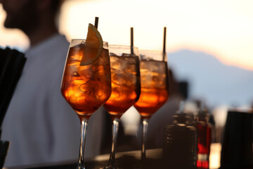sunset aperitif, cocktail with ice and orange slice