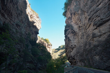A clearing at the entrance (exit) to a narrow winding canyon with steep cliffs.