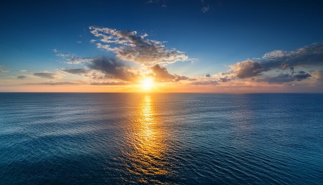 magnificence of sun descent upon vast expanse of sea horizon encapsulating a kaleidoscope of luminous hues serene waters and an ineffable bond between celestial and terrestrial realms