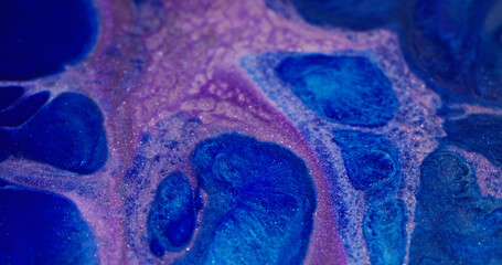 Purple glitter fluid. Sparkling paint. Defocused lilac blue color flowing liquid mix wet texture on...