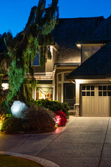 Entrance of luxury house with nice spring blossom landscape at night in Vancouver, Canada, North...