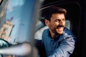 Happy man getting out of his car.