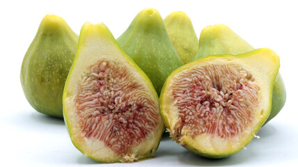 close-up of a group of green figs, one of which is cut in half, on a white background