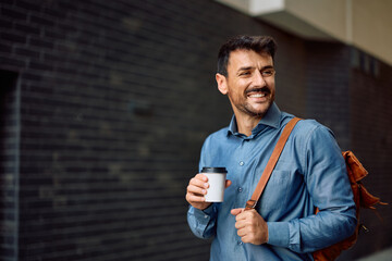 Happy entrepreneur having takeaway coffee while going to work.