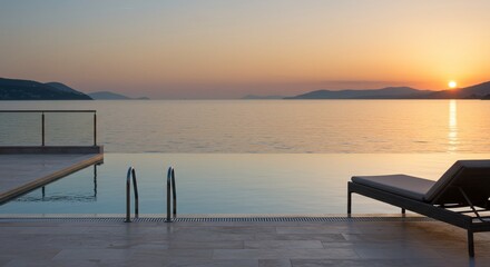Obraz premium Serene Infinity Pool at Sunset Overlooking Calm Ocean and Distant Mountains