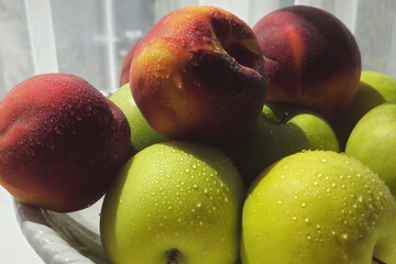 green apples and peaches in a bowl. organic food. healthy food diet