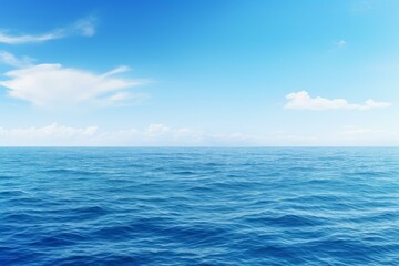 Fototapeta premium Deep blue ocean waves reflecting the clear sky with white clouds on a beautiful sunny day