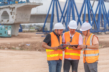 Group of asian engineers discuss about work at site of building under construction,The contractor...