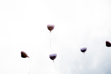 Heart-Shaped Balloons Rising into the Sky