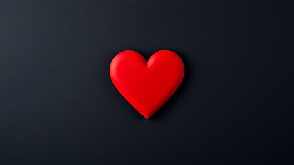 Minimalist red heart on dark textured background with directional lighting