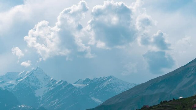4K Zoom In Time-lapse shot of clouds above the snowy Himalayan mountain peaks during the monsoon season as seen from Khangsar village in Lahaul and Spiti district, Himachal Pradesh, India.