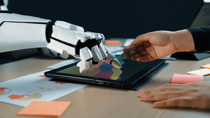 A dynamic interaction between a human hand and a robotic arm using a touchscreen tablet in a modern...
